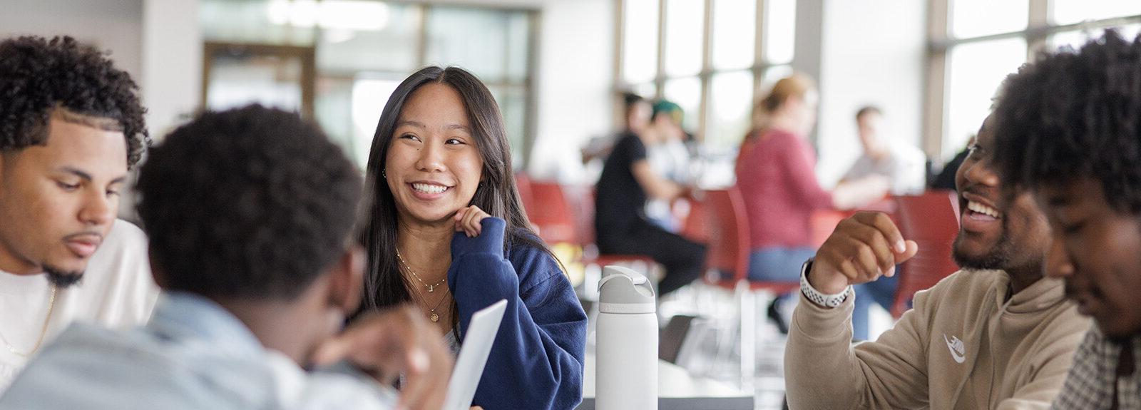 Male and female students talking and smiling